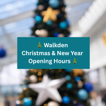 Walkden Christmas and New Year opening hours sign displayed over a festive Christmas tree inside Walkden Town Centre